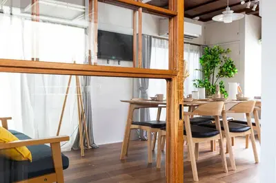 a dining room with a table with chairs and a tv at Ohanajaya 3min Garden View House 4 beds in Tokyo