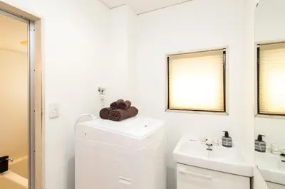 a white bathroom with a toilet and a sink at FIKA Shibuya Honmachi Entire building in Tokyo