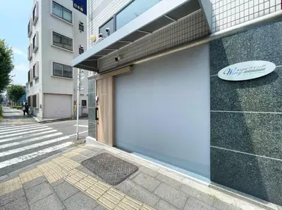 a white garage door on the side of a building at Yamato Residence Katsushika,10min toAsakusa Japanese style 1LDK Max10ppl in Tokyo