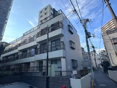 a tall white building with balconies on a street at Akabane Apart ment Wei hefuyan7190 in Tokyo