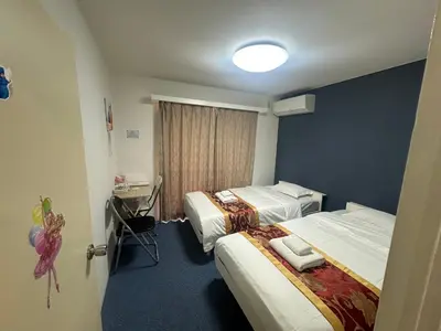 a hotel room with two beds and a desk at Akabane Apart ment Wei hefuyan7190 in Tokyo