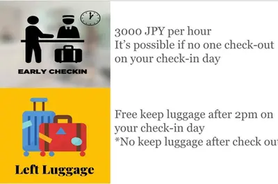a couple of signs with luggage and a clock at \u6771\u5411\u5cf66\u4e01\u76ee in Tokyo
