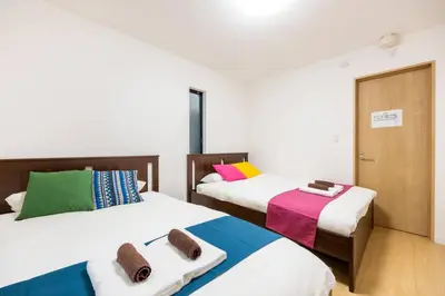 two beds with towels on them in a room at \u6771\u5411\u5cf66\u4e01\u76ee in Tokyo