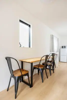 a dining room table with four chairs and a window at \u6771\u5411\u5cf66\u4e01\u76ee in Tokyo