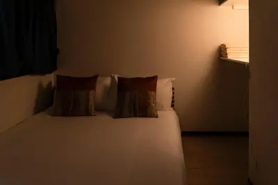 a bed with two pillows on it in a room at \u9ce5\u8d8a\u4e00\u6237\u5efa in Tokyo