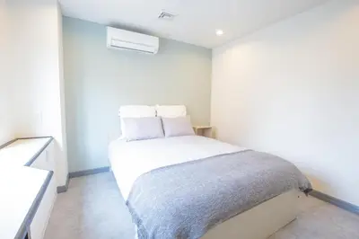 a bedroom with a large white bed in a room at Minutes from Sumiyoshi & Iconic Attractions & Sky Tree in Tokyo