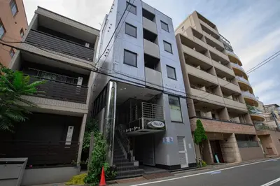 an apartment building on the side of a street at Minutes from Sumiyoshi & Iconic Attractions & Sky Tree in Tokyo