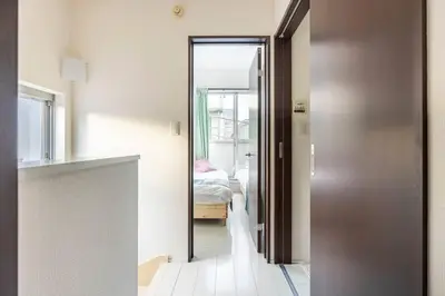 a hallway with a door leading to a bedroom at Crown\u6d77\u8fba in Tokyo