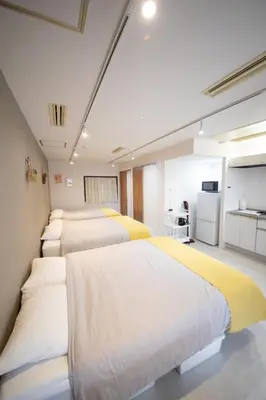 a row of beds in a room at Style Lab\u304a\u82b1\u8336\u5c4b1 in Tokyo