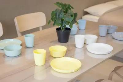 a table with white and yellow cups and plates and a potted plant at Style Lab\u304a\u82b1\u8336\u5c4b1 in Tokyo