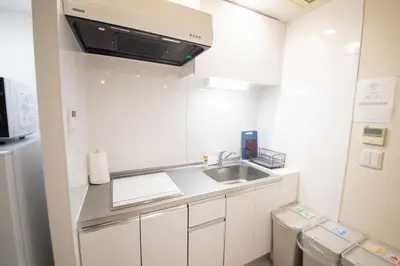 a small kitchen with a sink and a refrigerator at Style Lab\u304a\u82b1\u8336\u5c4b1 in Tokyo