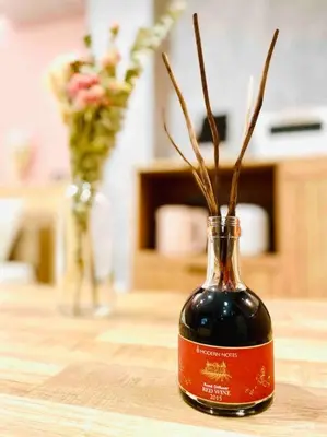 a bottle of wine sitting on a table with flowers at Class Kyodo in Tokyo