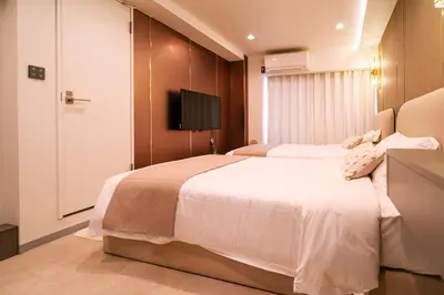 a hotel room with two beds and a television at \u4e09\u30ce\u8f2a \u5409\u539f in Tokyo