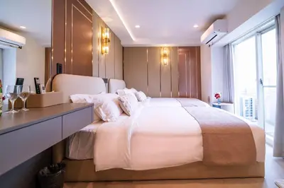 a bedroom with a large white bed and a desk at \u4e09\u30ce\u8f2a \u5409\u539f in Tokyo