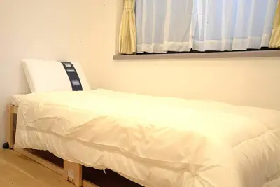 a white bed in a room with a window at \u9ad8\u5186\u5bfa\u4e2d\u91ceVilla in Tokyo