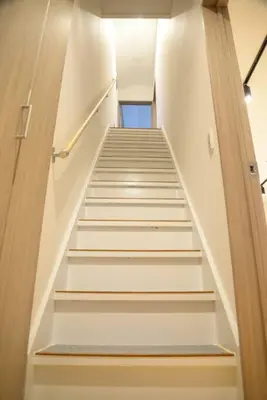 a stairway with white stairs in a building at \u9ad8\u5186\u5bfa\u4e2d\u91ceVilla in Tokyo