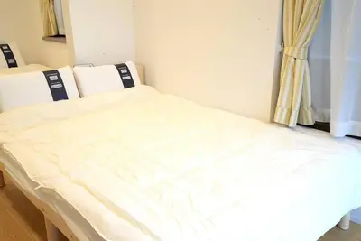 a white bed in a room with a window at \u9ad8\u5186\u5bfa\u4e2d\u91ceVilla in Tokyo