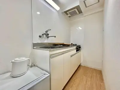 a small kitchen with a sink and a counter at Shinjuku YC Hostel-SJ0399 in Tokyo