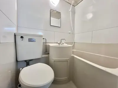 a white bathroom with a toilet and a sink at Shinjuku YC Hostel-SJ0399 in Tokyo