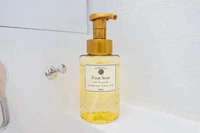 a bottle of liquid soap sitting on a sink at 67 Apt Nishishinjuku Premium in Tokyo