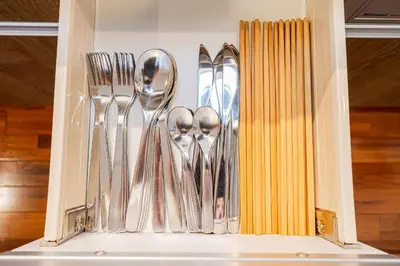 a drawer with silver spoons and forks and knives at 67 Apt Nishishinjuku Premium in Tokyo