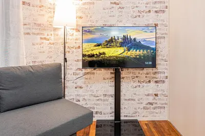 a living room with a couch and a painting on a wall at 67 Apt Nishishinjuku Premium in Tokyo