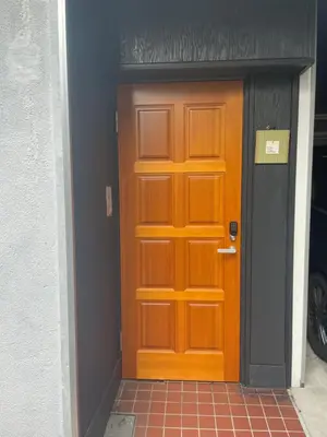 a wooden door in front of a building at Tatami-Tokyo studio apartment in Tokyo