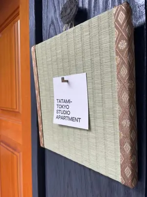 a sign on a door with a tie on it at Tatami-Tokyo studio apartment in Tokyo