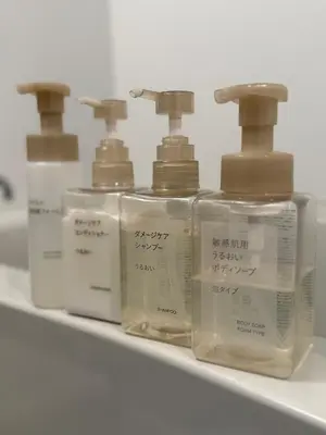a row of four bottles of soap on a shelf at Tatami-Tokyo studio apartment in Tokyo