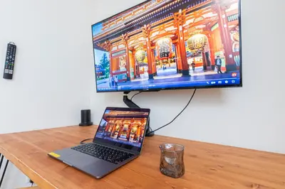 a laptop computer sitting on a desk with a monitor at Zen Home AKABANE in Tokyo