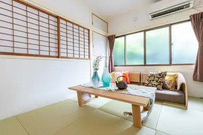 a living room with a couch and a table at Zen Home AKABANE in Tokyo