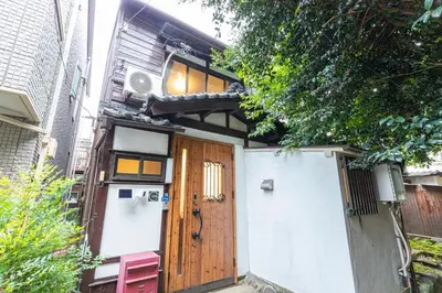 a house with a wooden door and a fence at Zen Home AKABANE in Tokyo