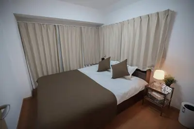 a bedroom with a large bed and a window at Shibuya Center Street 4 minutes direct access to Shinjuku and Harajuku and Omotesando in Tokyo