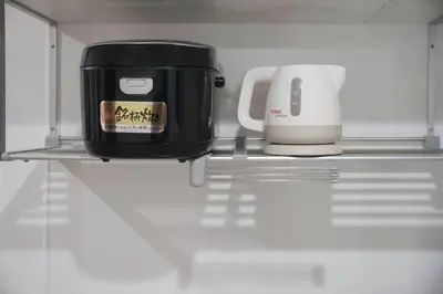 a coffee maker and a toaster on a shelf in a refrigerator at Shibuya Center Street 4 minutes direct access to Shinjuku and Harajuku and Omotesando in Tokyo