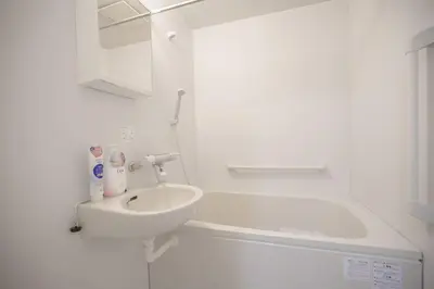a white bathroom with a sink and a bath tub at Shibuya Center Street 4 minutes direct access to Shinjuku and Harajuku and Omotesando in Tokyo
