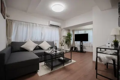 a living room with a couch and a table at Shibuya Center Street 4 minutes direct access to Shinjuku and Harajuku and Omotesando in Tokyo