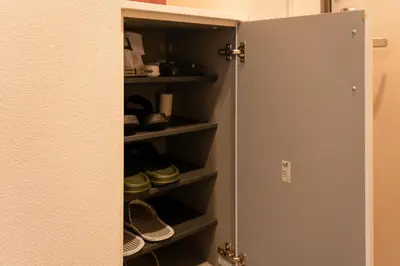 a closet with a door open with shoes in it at \u9326\u7cf8\u753a in Tokyo