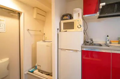 a small kitchen with a refrigerator and a microwave at \u9326\u7cf8\u753a in Tokyo