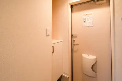 a bathroom with a toilet and a door at \u9326\u7cf8\u753a in Tokyo