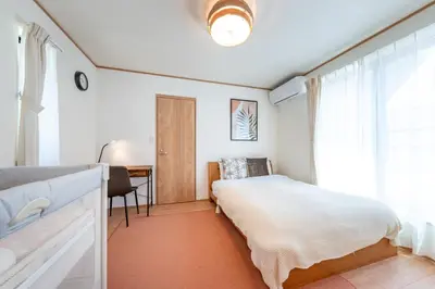 a bedroom with a bed and a desk and a window at HOTEL Zephyr Yotsugi - Vacation STAY 67085v in Tokyo