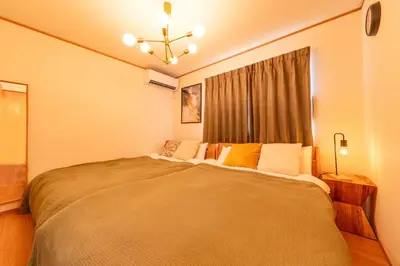a bedroom with a large bed in front of a window at HOTEL Zephyr Yotsugi - Vacation STAY 67085v in Tokyo