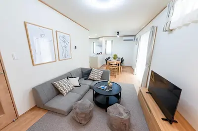 a living room with a couch and a tv at HOTEL Zephyr Yotsugi - Vacation STAY 67085v in Tokyo