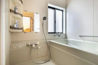 a bathroom with a bath tub and a sink at TRILOOP Higashi-Shinjuku in Tokyo