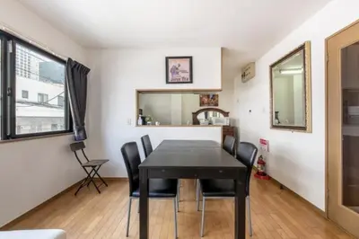a dining room with a black table and chairs at TRILOOP Higashi-Shinjuku in Tokyo