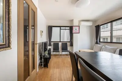 a dining room and living room with a table and chairs at TRILOOP Higashi-Shinjuku in Tokyo