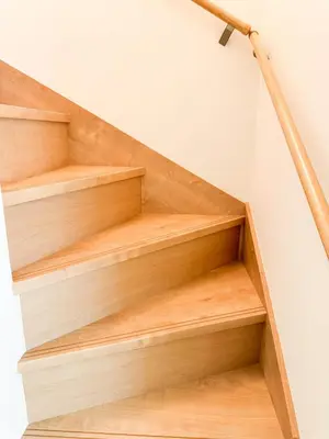 a set of wooden stairs with a rail at Triphome Shinjuku Takadanobaba Sakura House in Tokyo