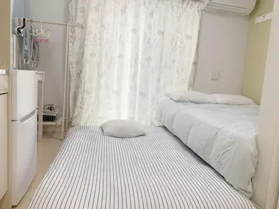 a small bedroom with two beds and a window at JR t akadababa subway 5 mins walk! Newly building \u65b0\u7bc9! \u9ad8\u7530\u99ac\u5834\u99c5 \u5f92\u6b69\u570f\u5185\u5927\u4eba\u6c17! Shinjuku\u65b0\u5bbf\u5708!\u9ad8\u901f\u65e0\u9650\u5236Wi-FI BC in Tokyo