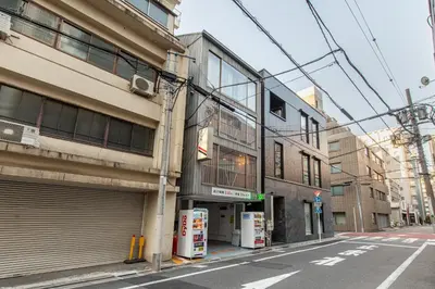 an empty city street with a building with a garage at \u30b0\u30e9\u30b9\u30ad\u30e3\u30d3\u30f3\u6d5c\u677e\u753ass Second and third floors in Tokyo