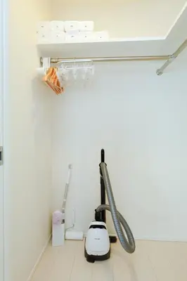 a room with a vacuum cleaner on the floor at Gran Duo Shirokane by Tranova in Tokyo