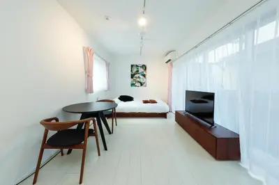 a room with a table and a bed and a bedroom at Gran Duo Shirokane by Tranova in Tokyo